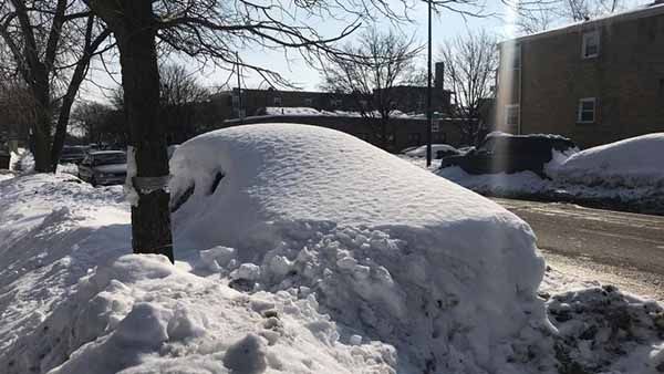 A car in Chicago covered in snow